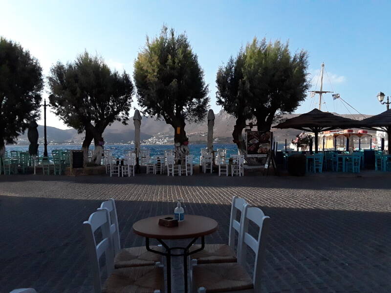 Cafe near the waterfront in Agia Marina, high winds driving waves in the bay.
