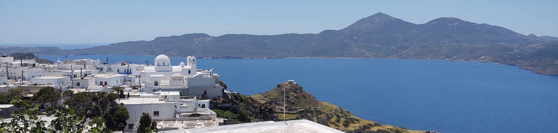View from Plaka over the volcanic caldera bay of Milos.