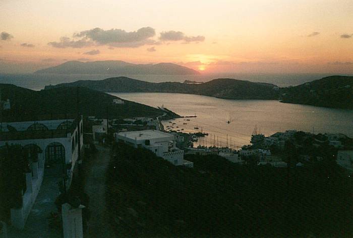 A view from the Hora down over the port of Ios as the sun sets into the Aegean.