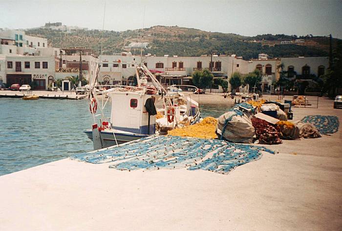 Fishing boats tied up and nets drying at Patmos harbor.