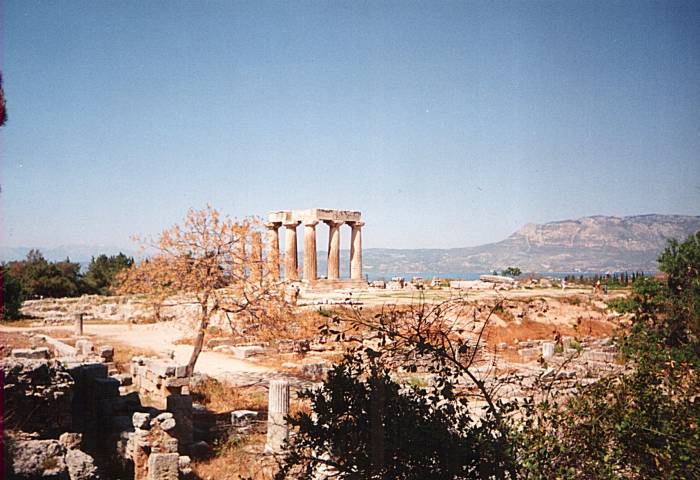 The Temple of Apollo in Corinth stands in front of the Gulf of Corinth.