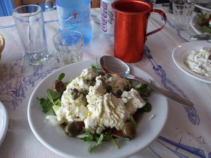 Local soft goat cheese on the Greek island of Ios.  Red anodized aluminum retsina pitcher.