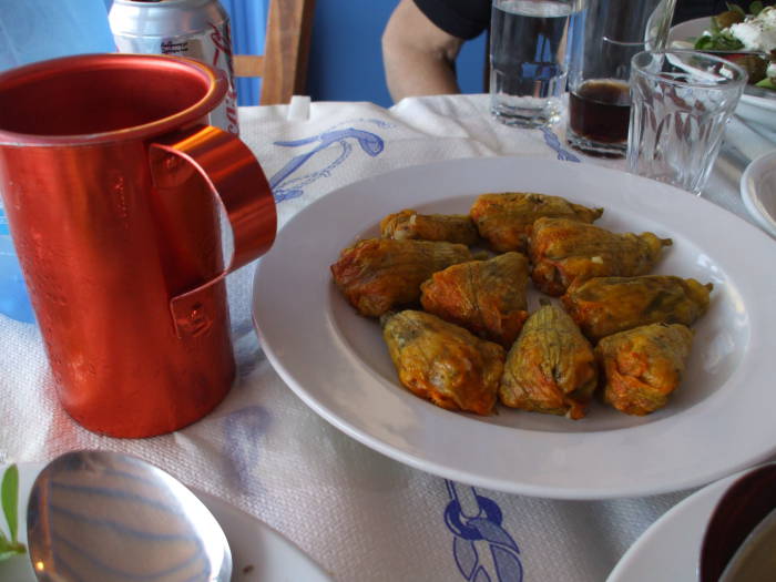 Fried zucchini blossoms and aluminum decanter of retsina on the Greek island of Ios.