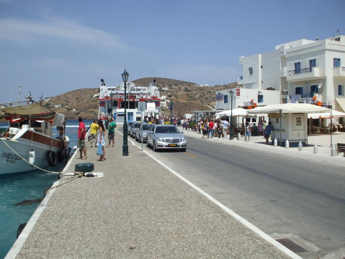 Fishing boat and businesses in the harbor on Ios island.