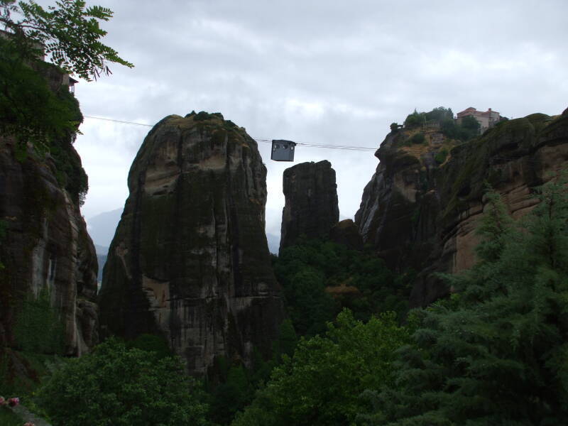 Small cable car carries a Greek Orthodox priest to monastery Moni Varlaam in Meteora.