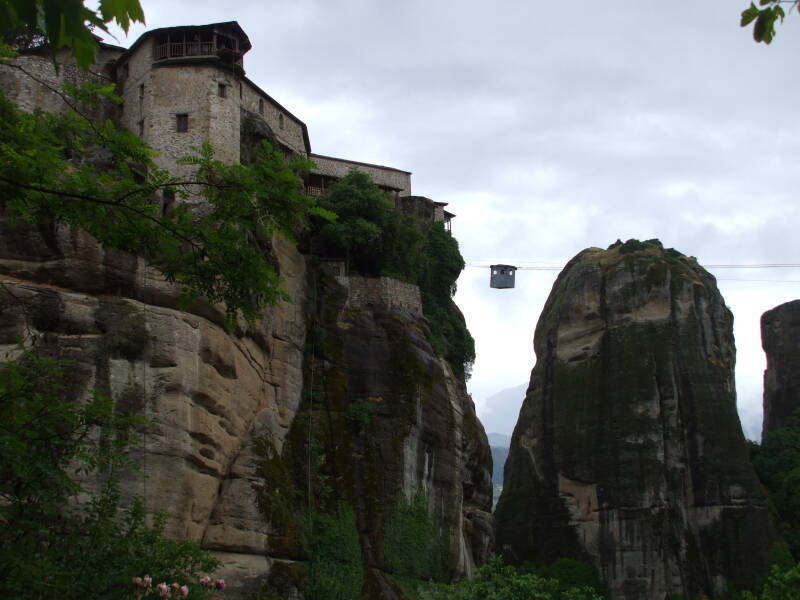 Small cable car carries a Greek Orthodox priest to monastery Moni Varlaam in Meteora.