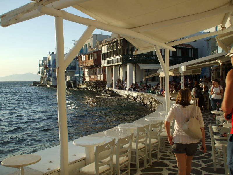 People gather for sunset at waterfront cafes in Little Venice in Hora, on Mykonos.