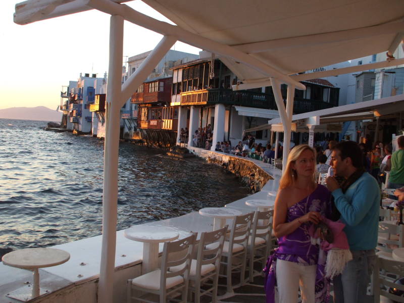 People gather for sunset at waterfront cafes in Little Venice in Hora, on Mykonos.