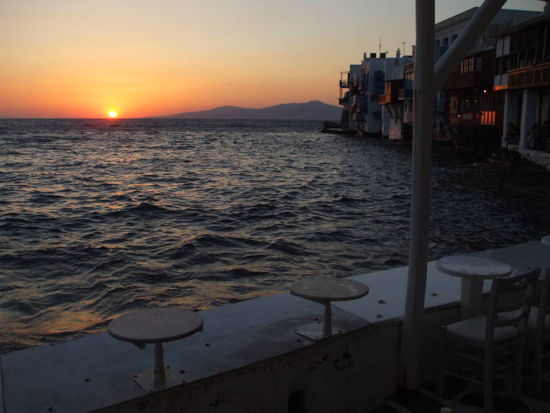 People gather for sunset at waterfront cafes in Little Venice in Hora, on Mykonos.