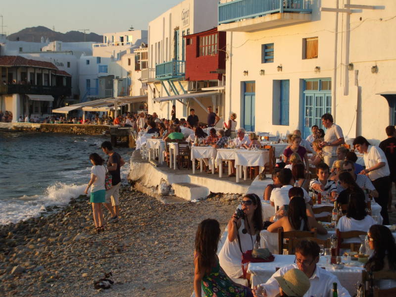 People gather for sunset at waterfront cafes in Little Venice in Hora, on Mykonos.