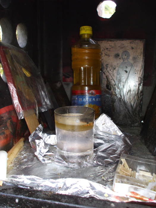 Icons and oil lamp in a Greek Orthodox shrine between Kastraki and Kalambaka, below Meteora.