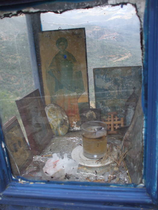 Oil lamp and icons in a Greek Orthodox shrine at Delphi.