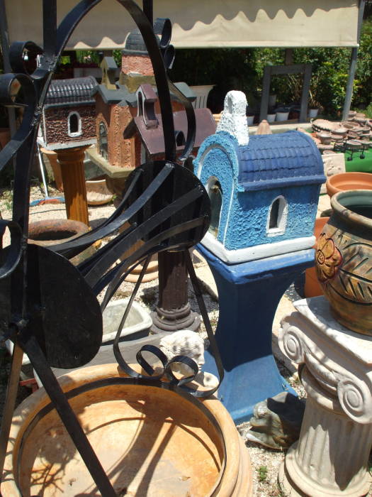Greek Orthodox shrines for sale in a garden supply business in Nafplio.