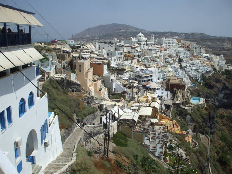 View across the town of Fira on the Greek island of Santorini, toward Moni Profiti Elias, the highest point on the island.
