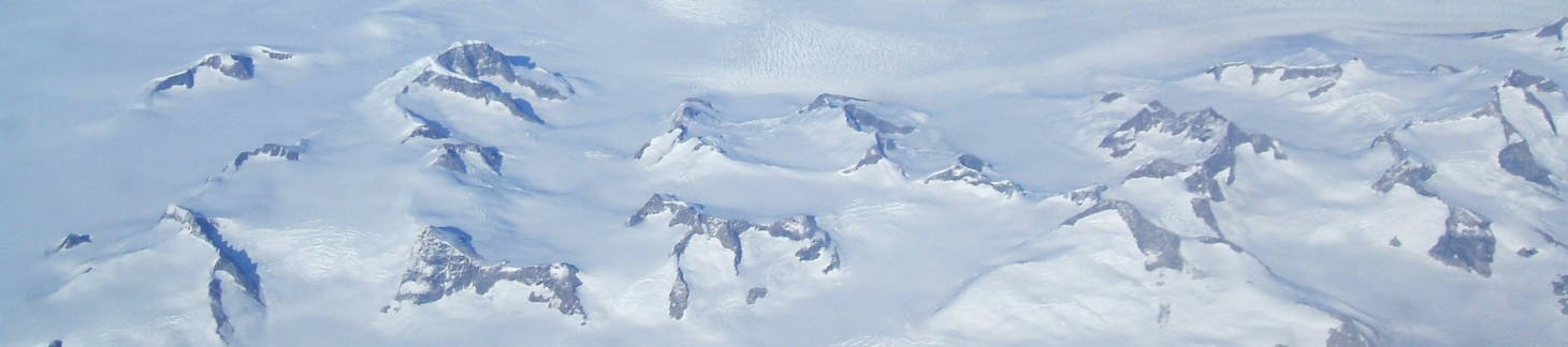 Mountains poking through the snow in Greenland.