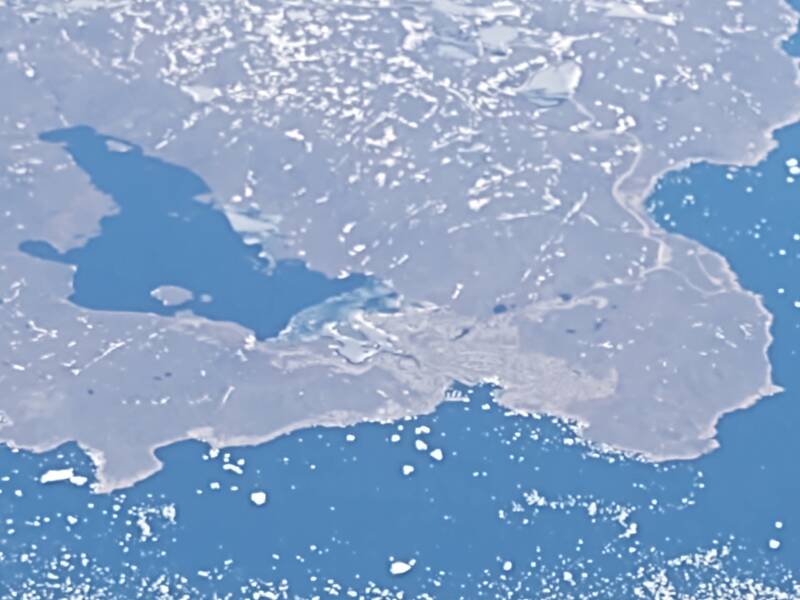Flying across southern Greenland from north of Prince Christian Sound to just south of Qaqortoq, approaching the Labrador Sea, on board AF 136 2022-05-19. Fuzzy view of Qaqortoq with 6.690x digital zoom.