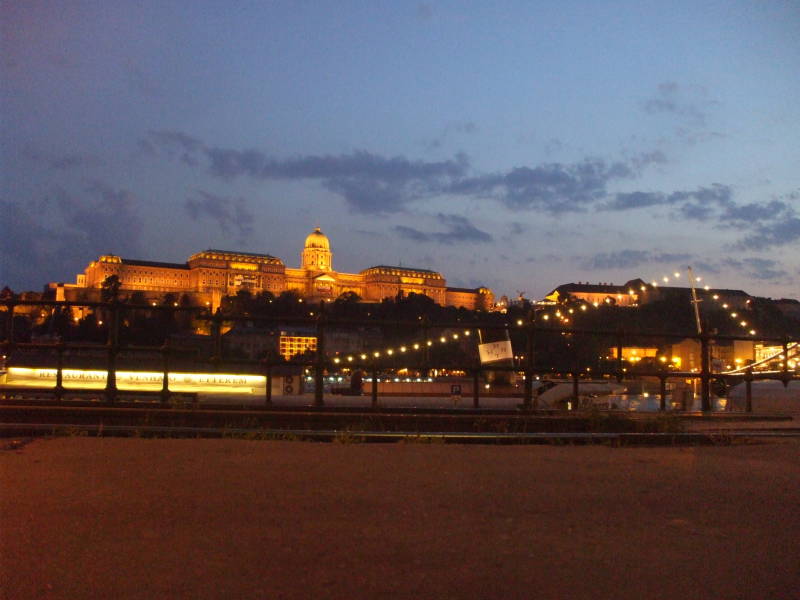 Castle Hill and the Chain Bridge lighted at night in Budapest.