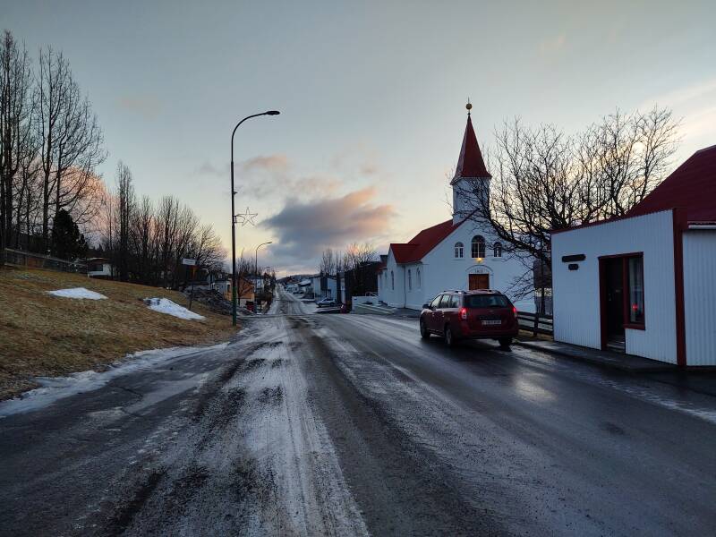 Icy streets and parking lot near the grocery store, liquor store, and post office in Fáskrúðsfjörður town.