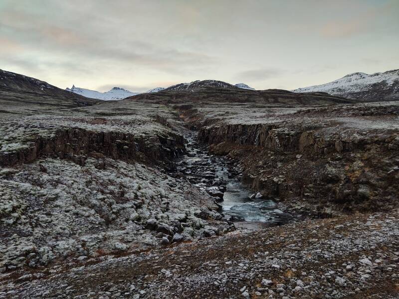 Slippery road crossing a rugged stream near Breiðdalsvík.