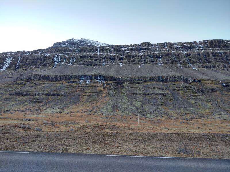 Volcanic basalt layers above the highway near Djúpivogur.