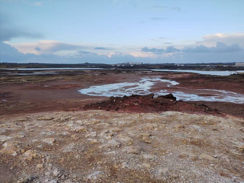 Gunnuhver hot springs with the Reykjanesvirkjun thermal and electrical power plant in the background.