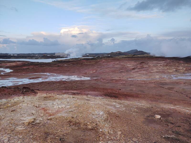 Gunnuhver hot springs with the Reykjanesvirkjun thermal and electrical power plant in the background.