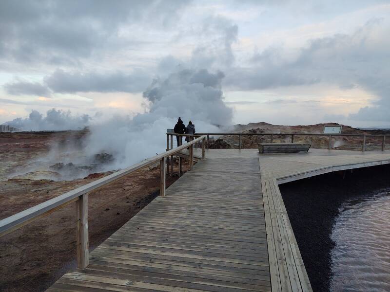 Visitors on the wooden walkway overlooking the Gunnuhver hot springs.