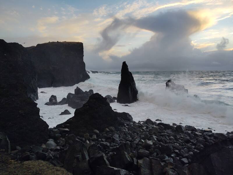 Large waves crashing into the Reykjanestá point beyond Reykjanes Lighthouse.