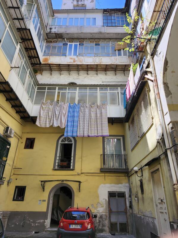 Four floors, three of them with glassed-in balconies, overlooking the central court open to the sky.