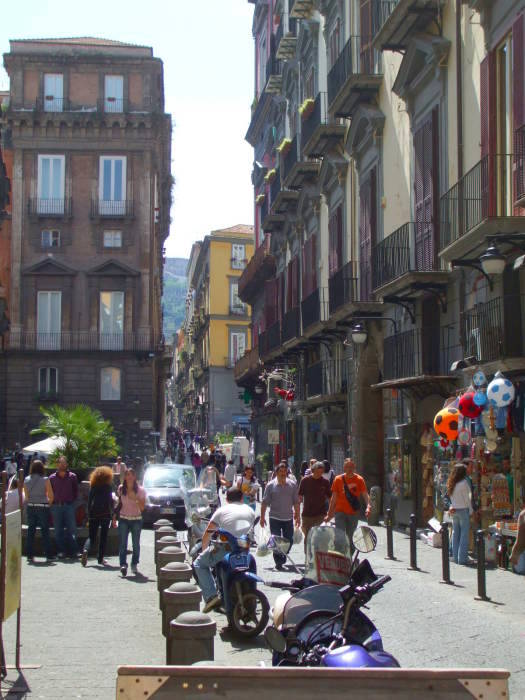 A busy street in Naple's Centro Storico: motor scooters, people on errands.