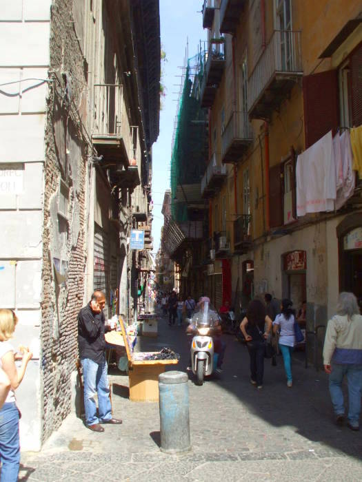 A vendor of sunglasses and mobile phone cases along side street in Naple's Centro Storico.