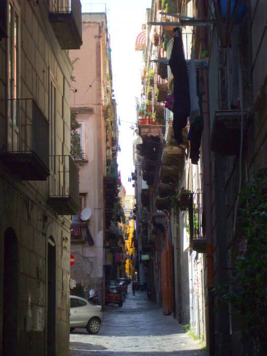 Narrow streets with laundry hanging overhead in the Centro Storico in Naples.