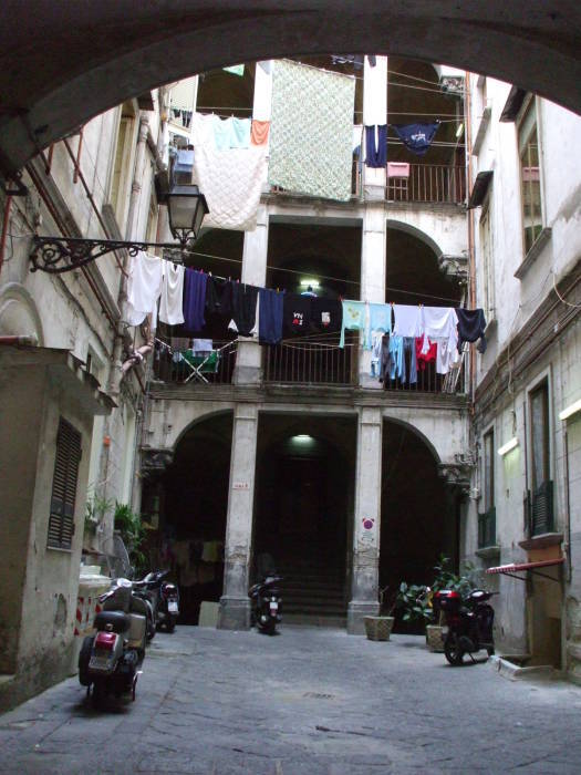 Enclosed open courtyard inside an old building in the Centro Storico in Naples.