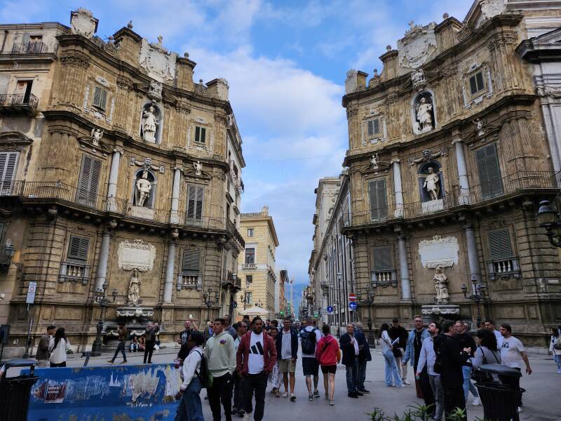 People standing and walking in Quattro Canti.