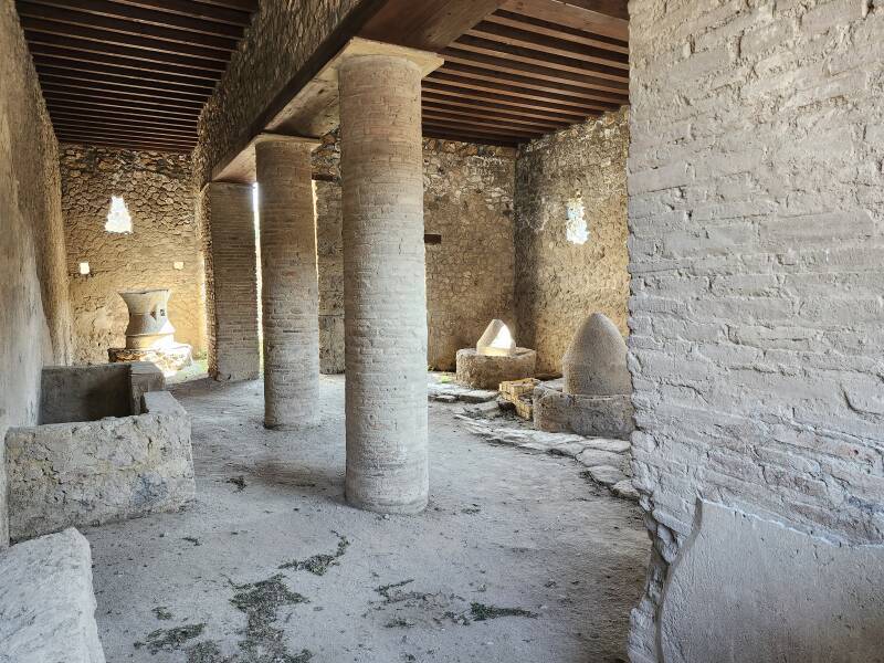 Grain mills in a Pompeii workshop.