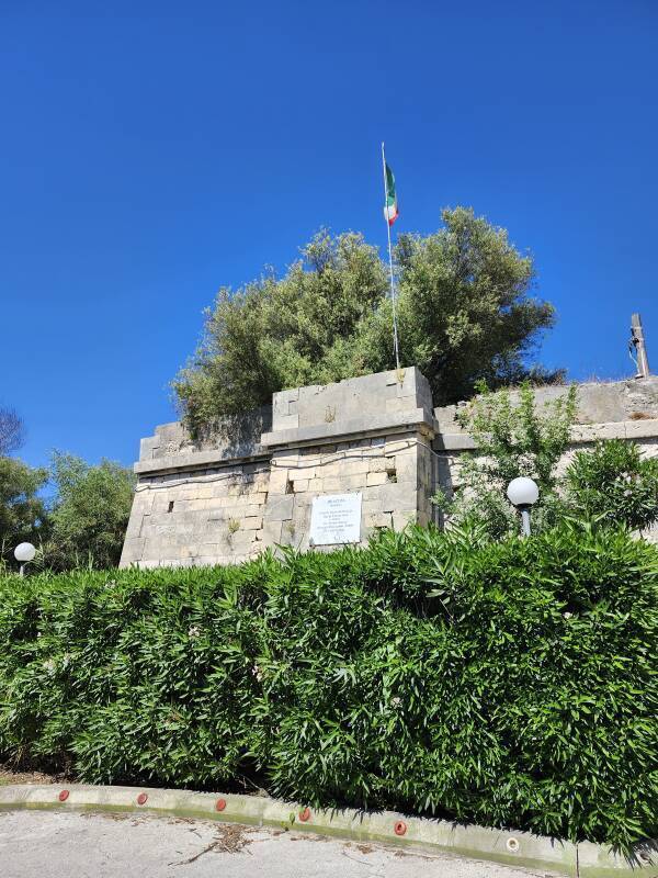 Historic marker and Italian flag on the 1943 bridge abutment.