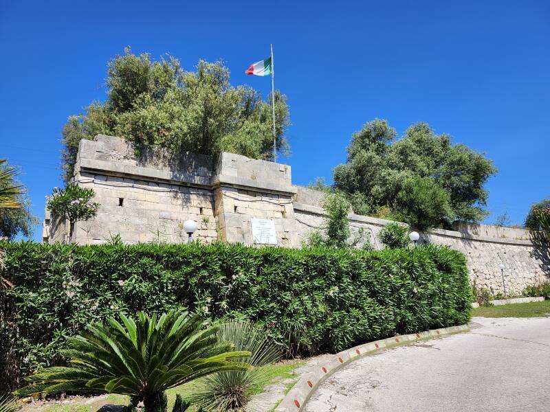 Historic marker and Italian flag on the 1943 bridge abutment.