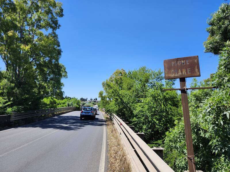 Old rusty sign reading 'FIUME CIANE' at a small second span.