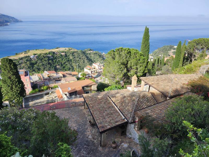 Buildings down a steep slope to the sea.