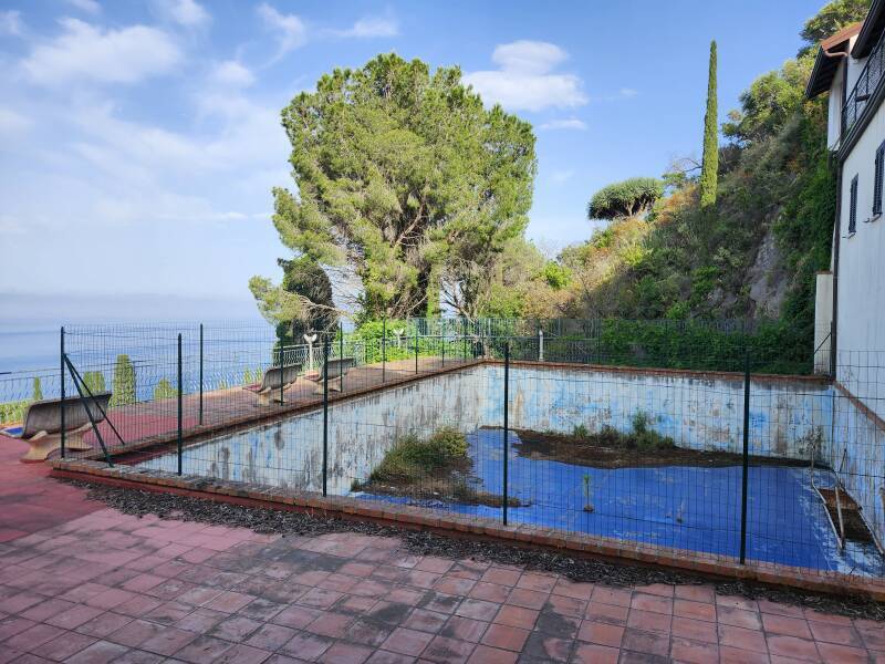 Empty swimming pool on a steep slope.
