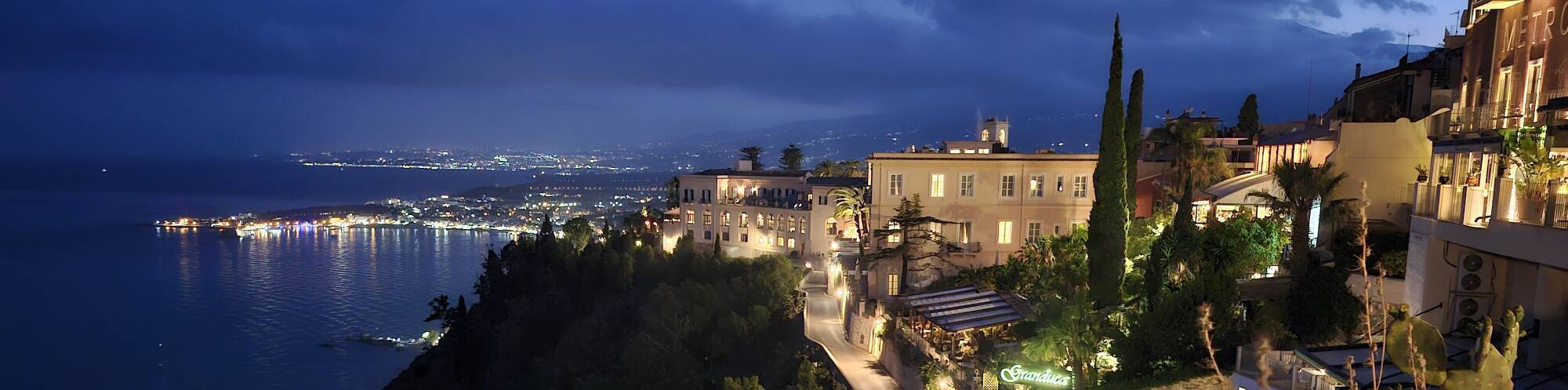 Evening view south from Piazze IX Aprile: luxury hotel with Kesselring's headquarters, Naxos, and Etna.