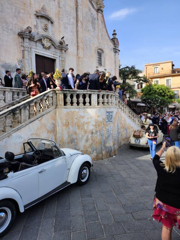 Mob of people observing the exit from a wedding in Chiesa di san Giuseppe on Piazza IX Aprile.