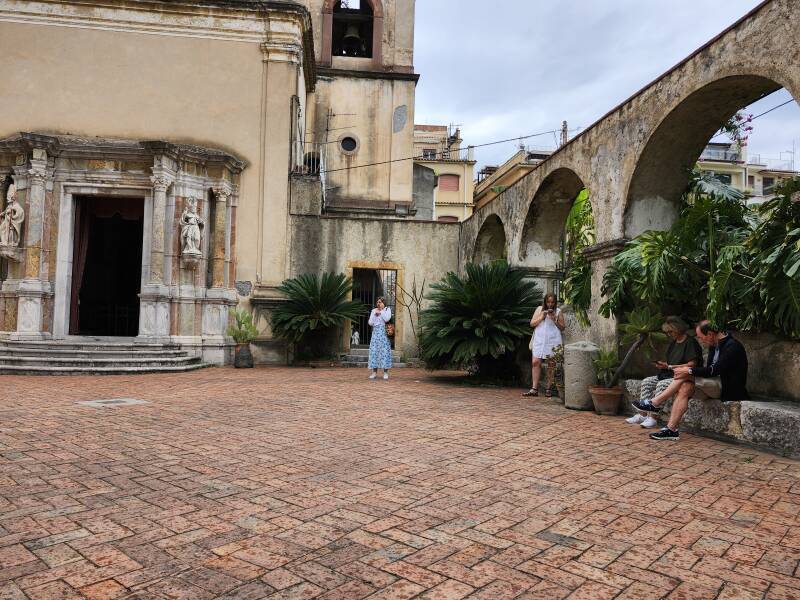 Americans shouting into their phones in the courtyard.
