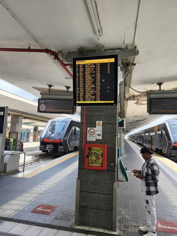Man using an Italian railway ticket validation device.