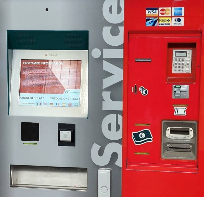 Preparing to pay for a train ticket purchased through a vending machine.