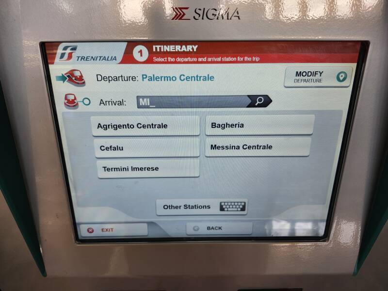 Selecting arrival station, and optionally, departure station, on the touch screen of a Trenitalia ticket vending machine.