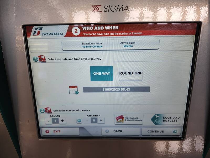 Selecting date and one way versus round trip on the touch screen of a Trenitalia ticket vending machine.
