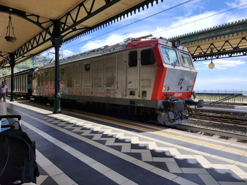 Freight train passing through Taormina-Giardini station.