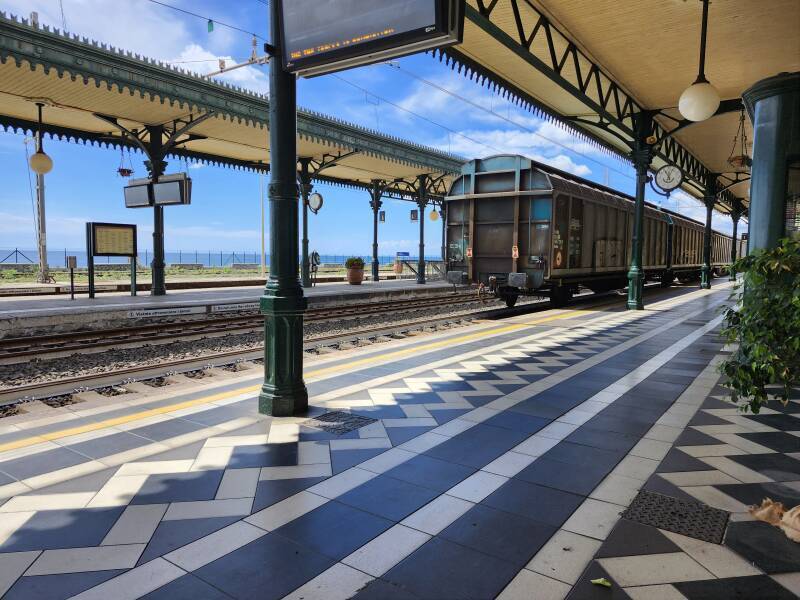 Freight train passing through Taormina-Giardini station.
