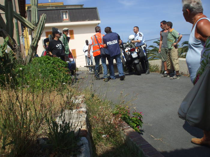 Italian paramedics or emergency medical technicians as the police hurry.